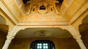 An ornate architectural interior with detailed carvings and a chandelier. - Hotel Desert Tulip (Jaisalmer)