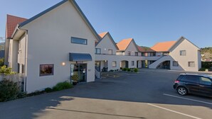 A modern building with a reception area, multiple rooms, and a parking lot.