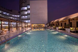 Relax by the rooftop pool surrounded by comfortable lounge seating.