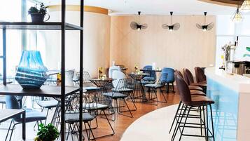 Enjoy dining in a contemporary space with various seating options and a large window.