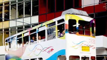 A colorful double-decker tram in front of the ibis hotel.