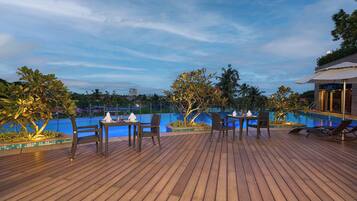 Guests can enjoy a relaxing poolside experience with comfortable seating and lush surroundings.