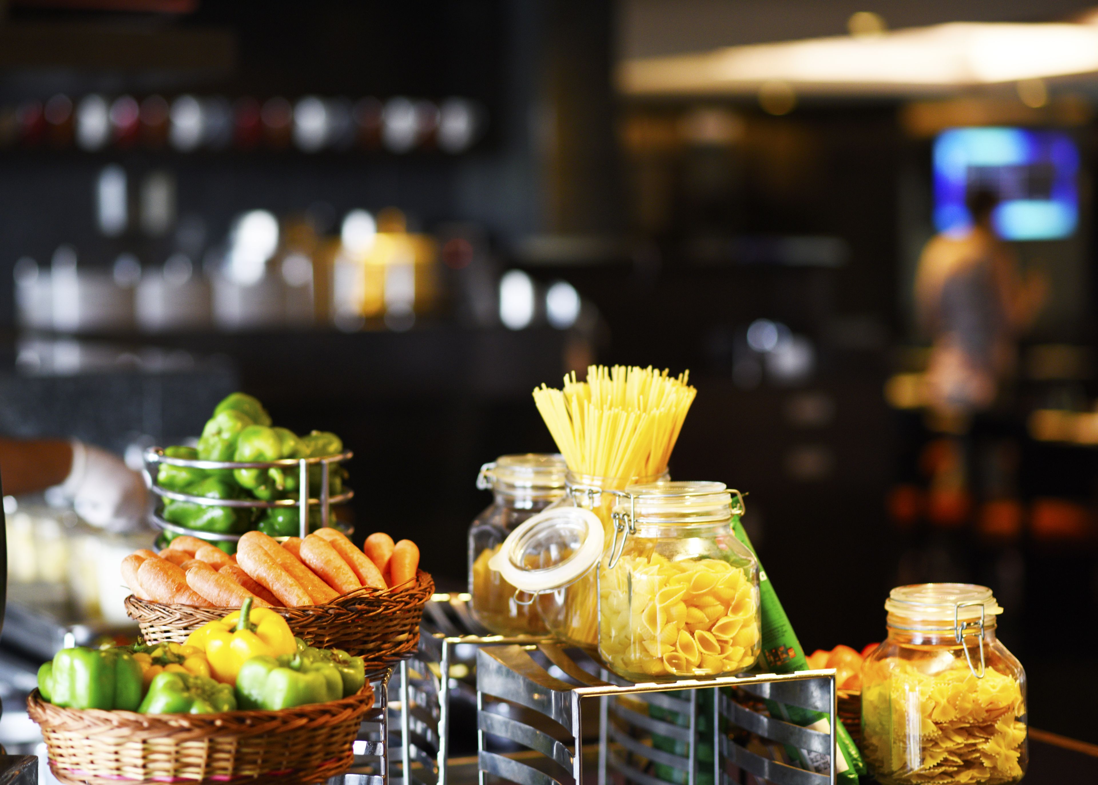 A buffet with various food items including bread, pasta, and vegetables.