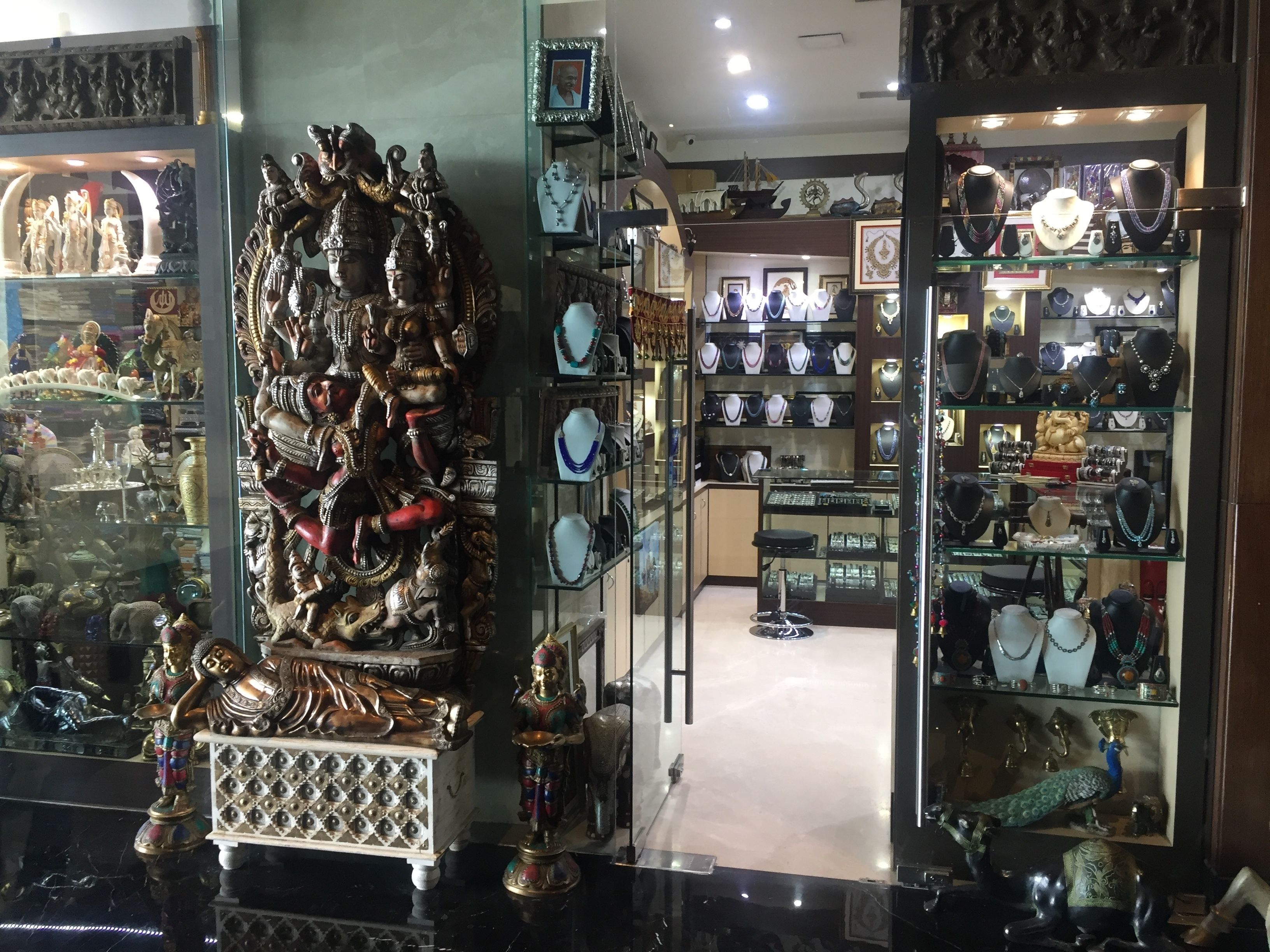 A jewelry store with glass display cases and shelves filled with various jewelry items.
