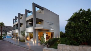 A modern hotel named "Anna's House" with a pool, outdoor seating, and a well-lit entrance. - Annas House (Apokoronas)