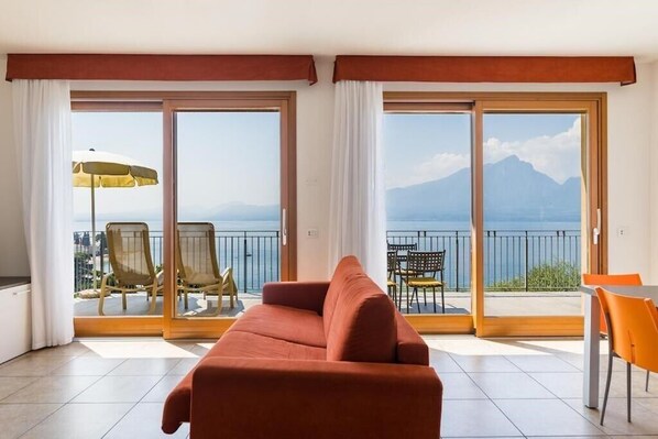 Comfort Apartment | Living area | 32-inch LCD TV with satellite channels, TV - Residence La Corte Danese (Torri del Benaco)