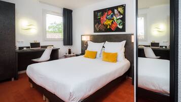 A modern hotel room with a large bed, a desk, and a chair. There is a painting on the wall and a window with curtains.