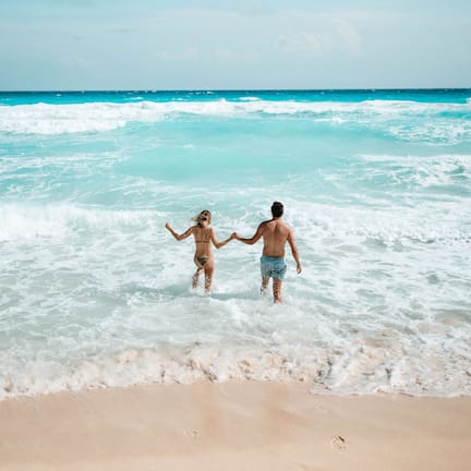 On the beach, white sand, sun loungers, beach umbrellas