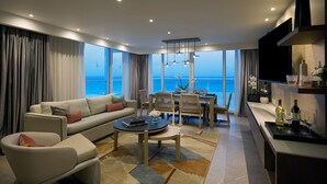A modern living room with a sofa, coffee table, and dining area. - Hard Rock Hotel Cancun -  All Inclusive  (Cancun)