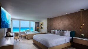 A modern hotel room with a large bed, a desk, a TV, a jacuzzi, and a view of the ocean. - Hard Rock Hotel Cancun -  All Inclusive  (Cancun)