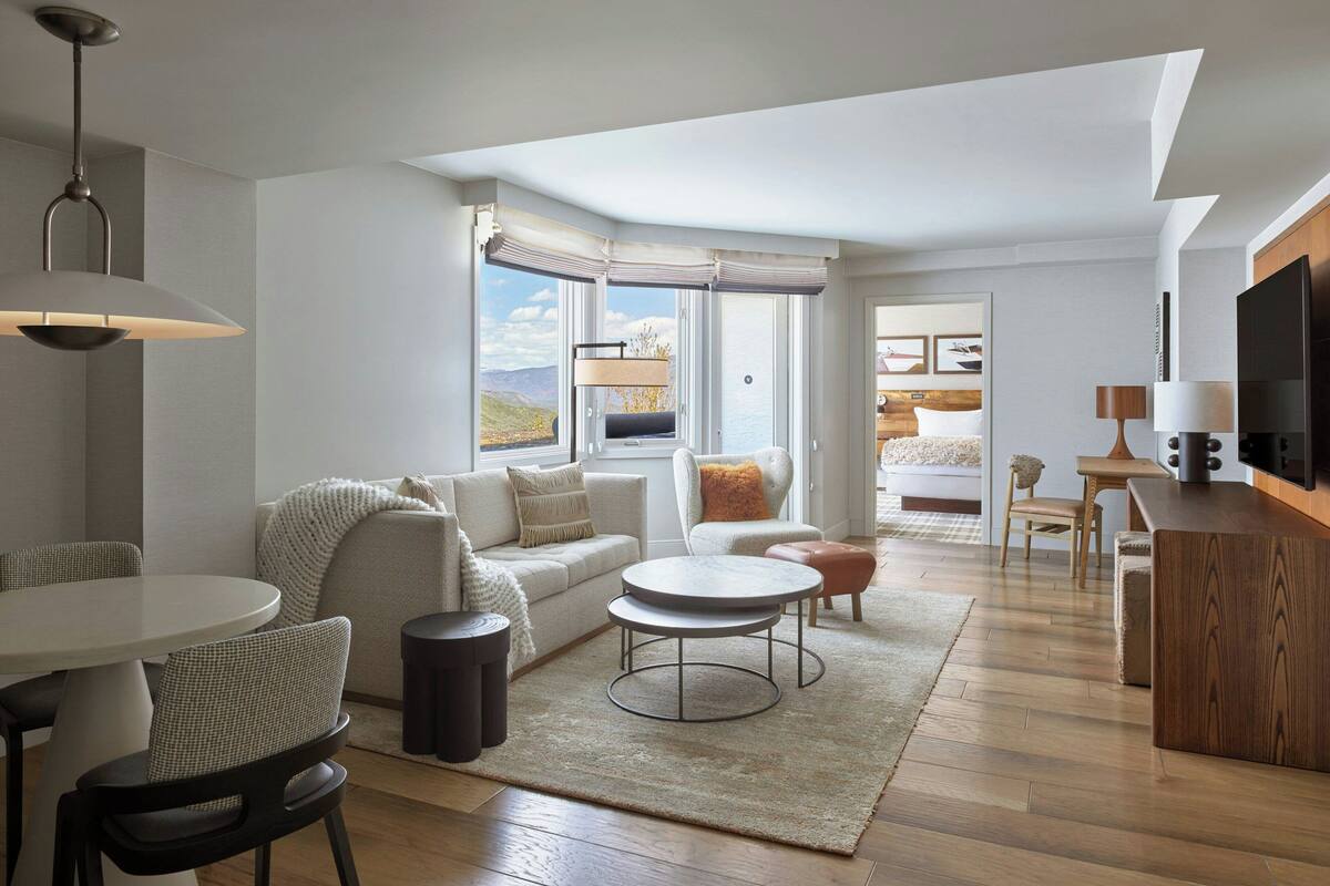 Un salon moderne avec un canapé, une table basse et un coin repas.