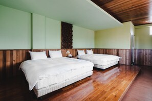 A room with two beds, wooden flooring, and a wooden wall panel. - Fanzhalan Guest House (Yuchi)