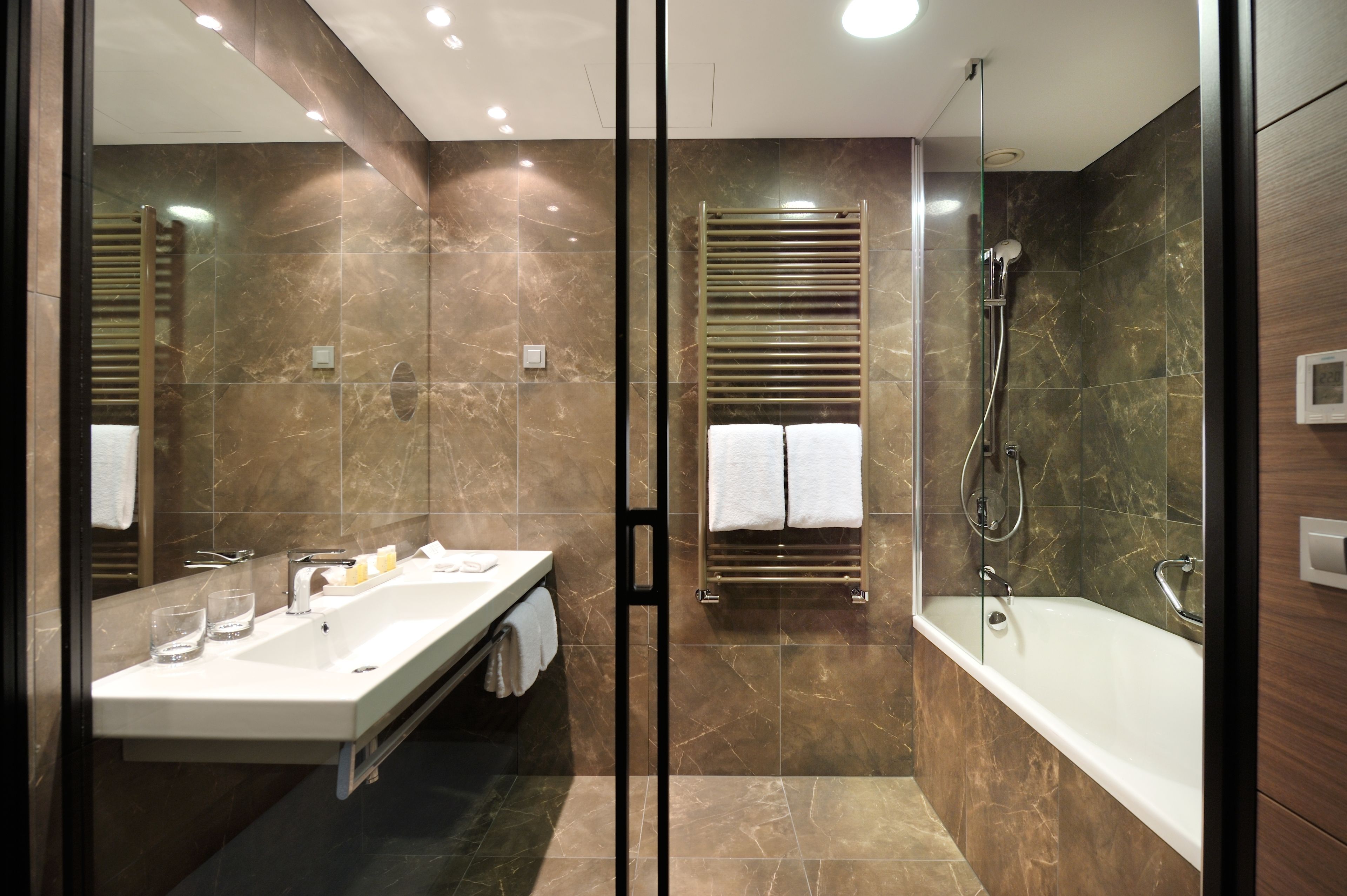 junior suite, 1 king bed | bathroom | rainfall showerhead, hair dryer, slippers, towels