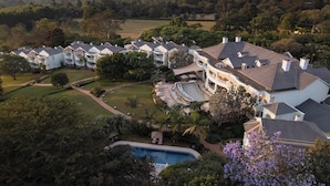 A large resort with multiple guest buildings, a swimming pool, and landscaped gardens. - Hemingways Nairobi (Nairobi)