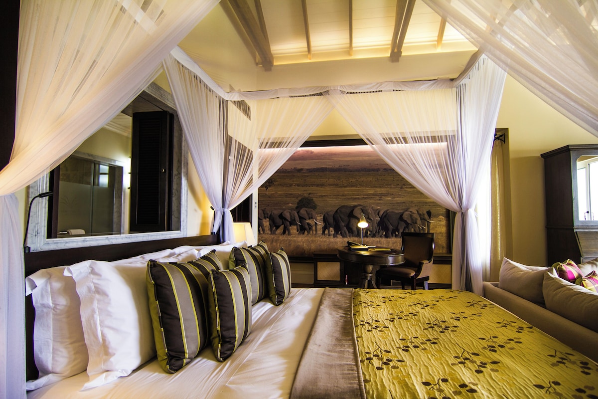 A room with a bed, a desk, and a chair.