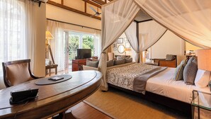 A bedroom with a bed, a desk, a chair, a television, and a balcony with curtains. - Hemingways Nairobi (Nairobi)