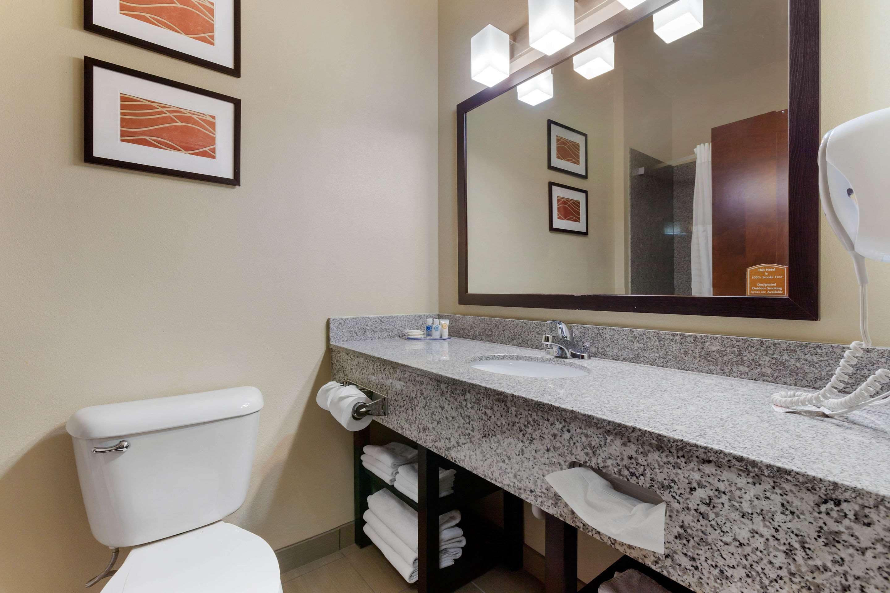 desk, iron/ironing board, bed sheets, alarm clocks