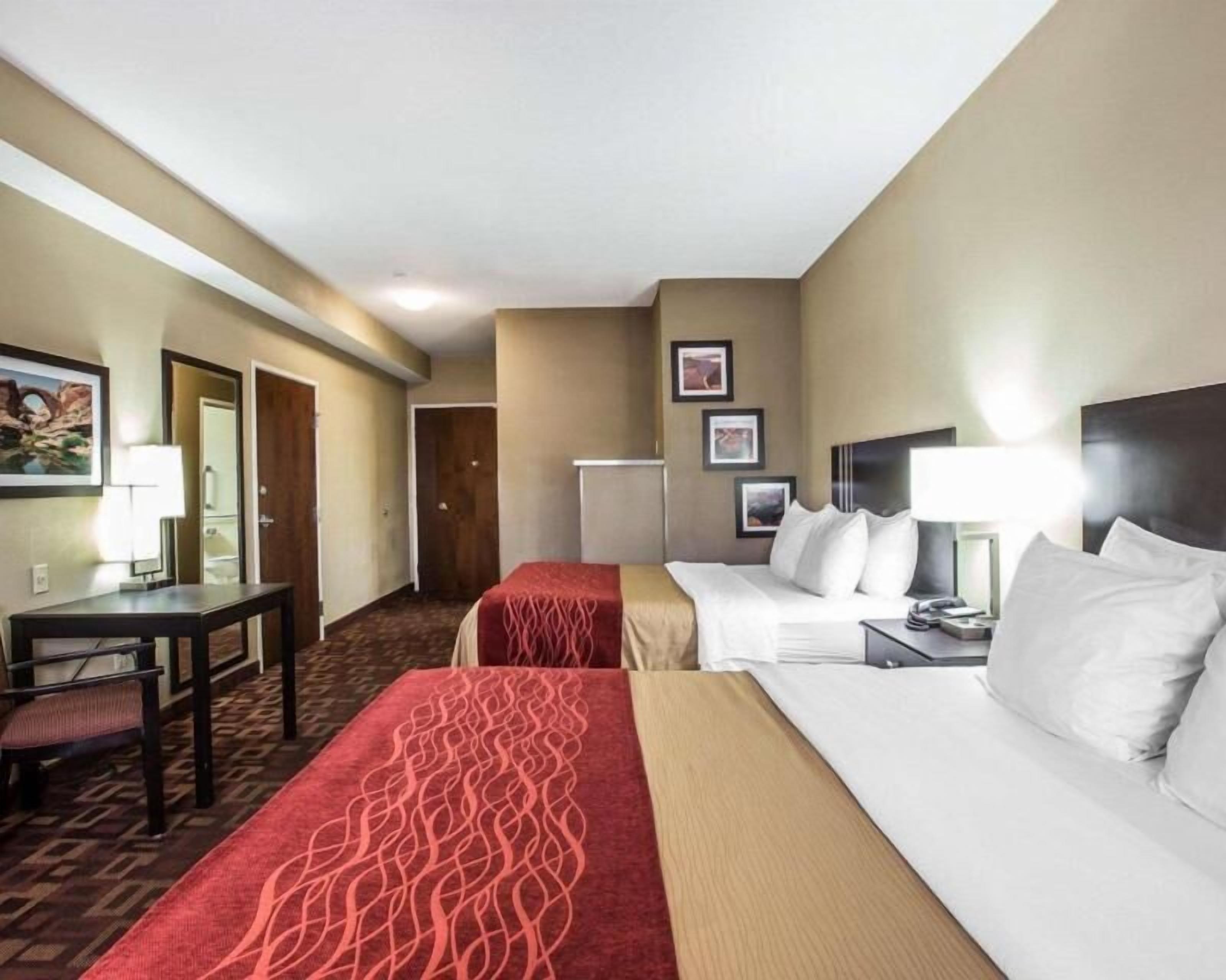 Desk, iron/ironing board, bed sheets, alarm clocks