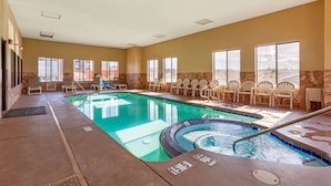 An indoor swimming pool with lounge chairs, a hot tub, and a view of a desert landscape through large windows. - Comfort Inn & Suites Page at Lake Powell (Page)