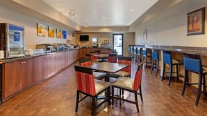 A spacious hotel lobby with a long counter, multiple seating areas, and a television screen. - Comfort Inn & Suites Page at Lake Powell (Page)