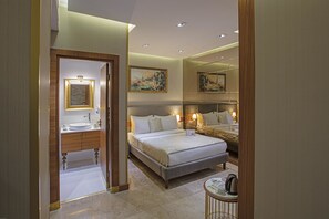 A hotel room with a large bed, a bathroom with a vanity, and a mirror. - Nowy Efendi Hotel - Special Class (Istanbul)