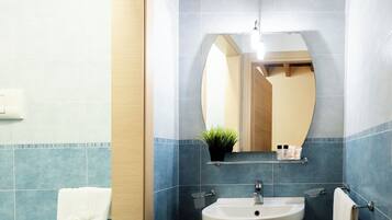 Deluxe Room, City View | Bathroom | Shower, free toiletries, hair dryer, slippers