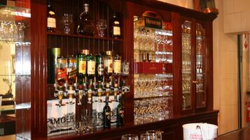 A bar area with various liquor bottles and glasses.