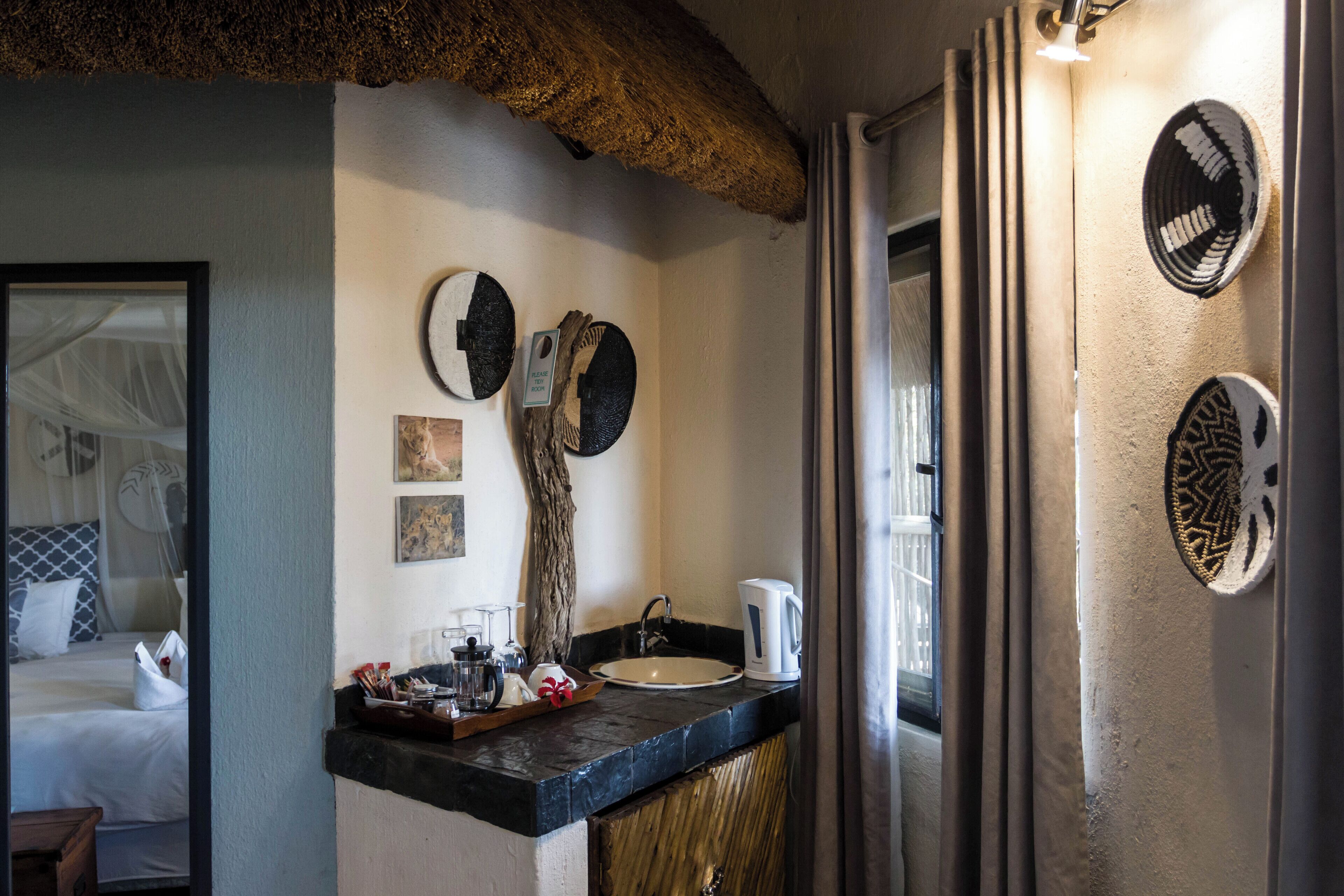 A bathroom with a sink, mirror, and decorative wall art.