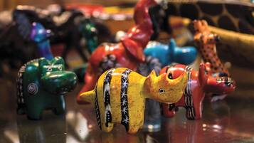 A collection of colorful ceramic animal figurines on a reflective surface.