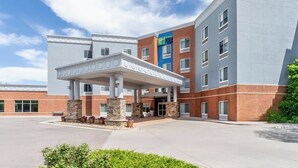 A hotel with a covered entrance, a brick facade, and a sign for Hyatt. - Holiday Inn Express Hotel & Suites Denver North - Thornton by IHG (Thornton)