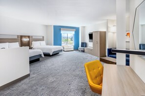A hotel room with two beds, a desk, a chair, a wardrobe, and a large window offering a view.
