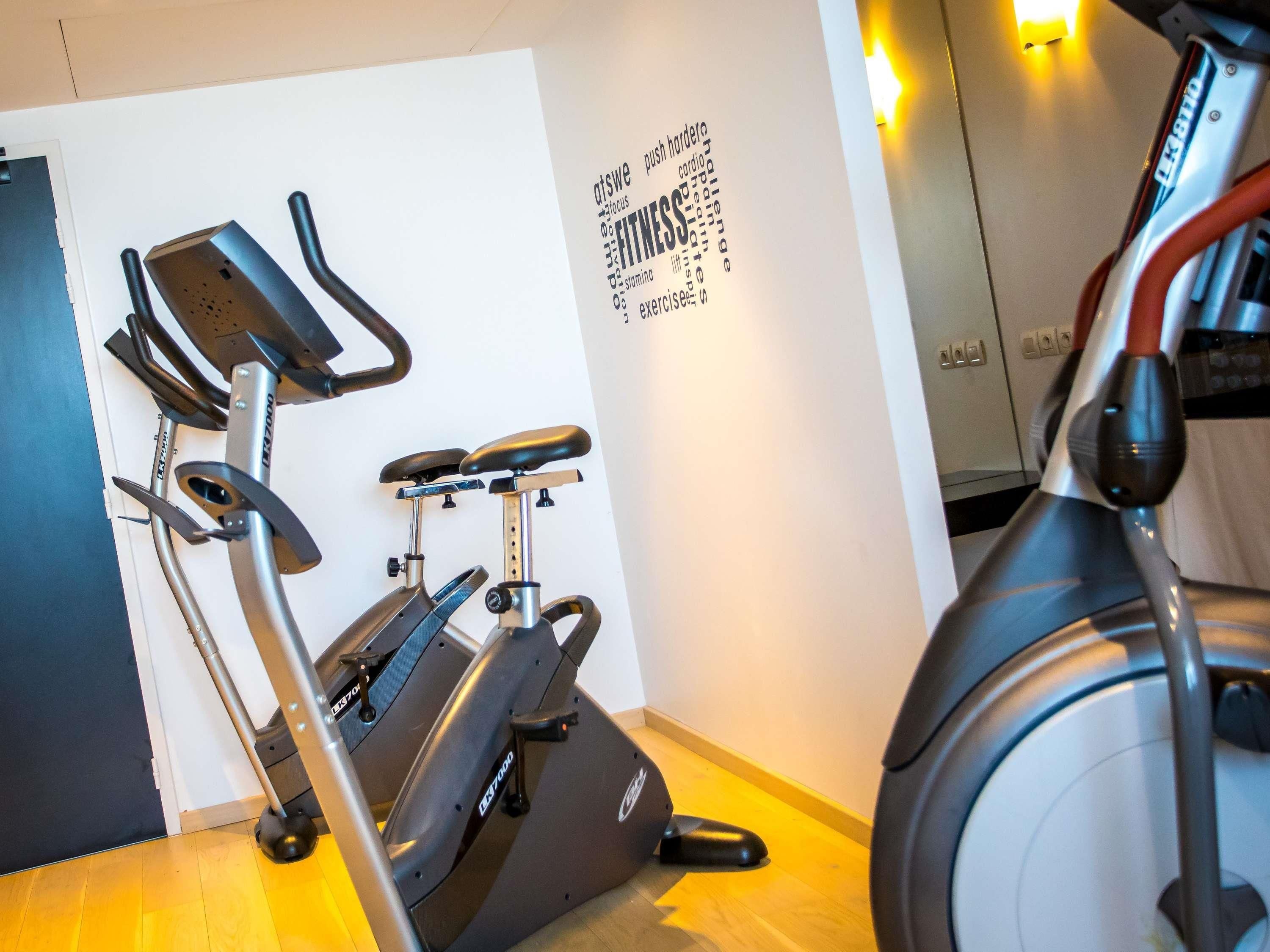 A home gym with stationary bikes and a treadmill.