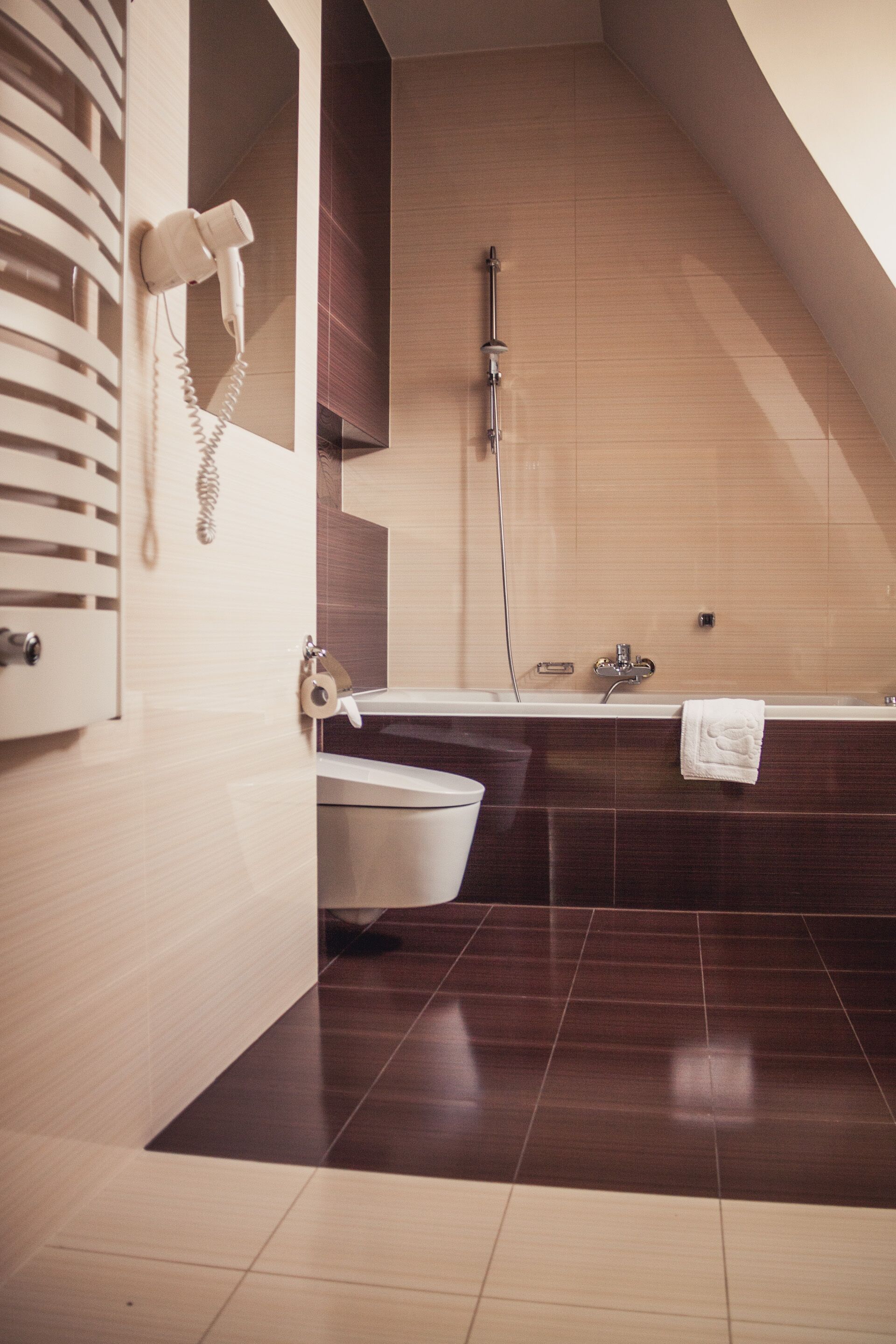 A modern bathroom with a shower, toilet, and bathtub.