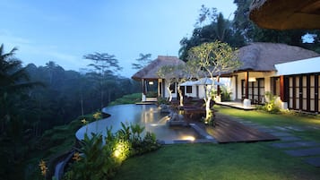 Outdoor pool, an infinity pool, pool umbrellas, pool loungers