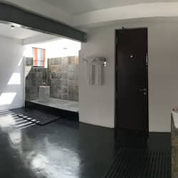 Relax in a spacious bathroom with a large bathtub, sink, and shower area.