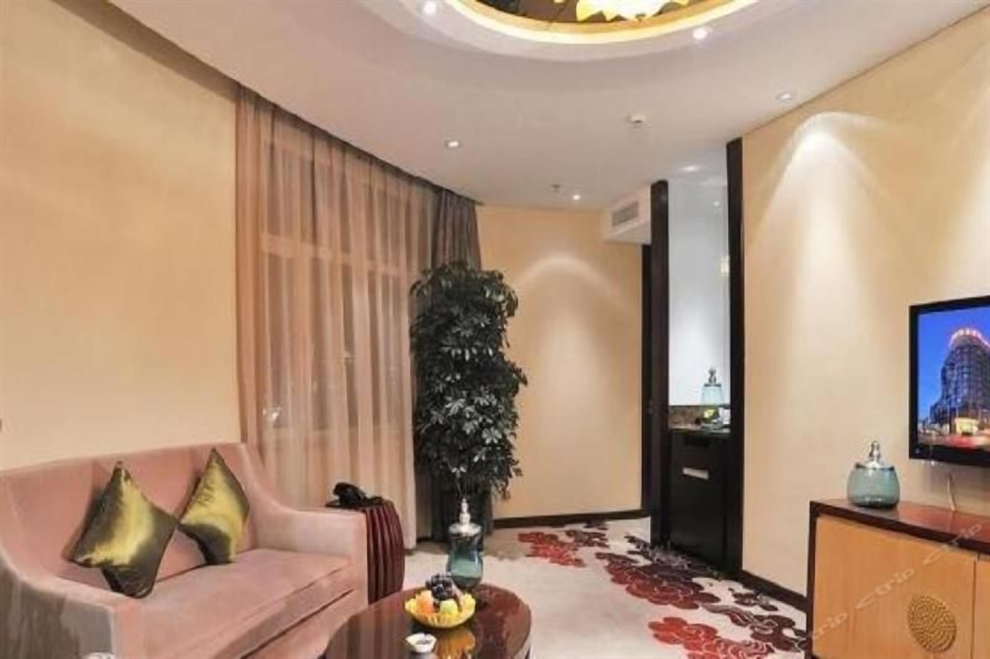 A modern living room with a sofa, a coffee table, and a television.
