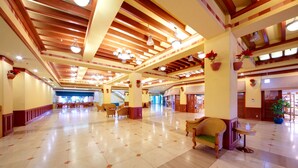 A spacious lobby with high ceilings, wooden beams, and potted plants. - Pacific Hotel Okinawa (Naha)