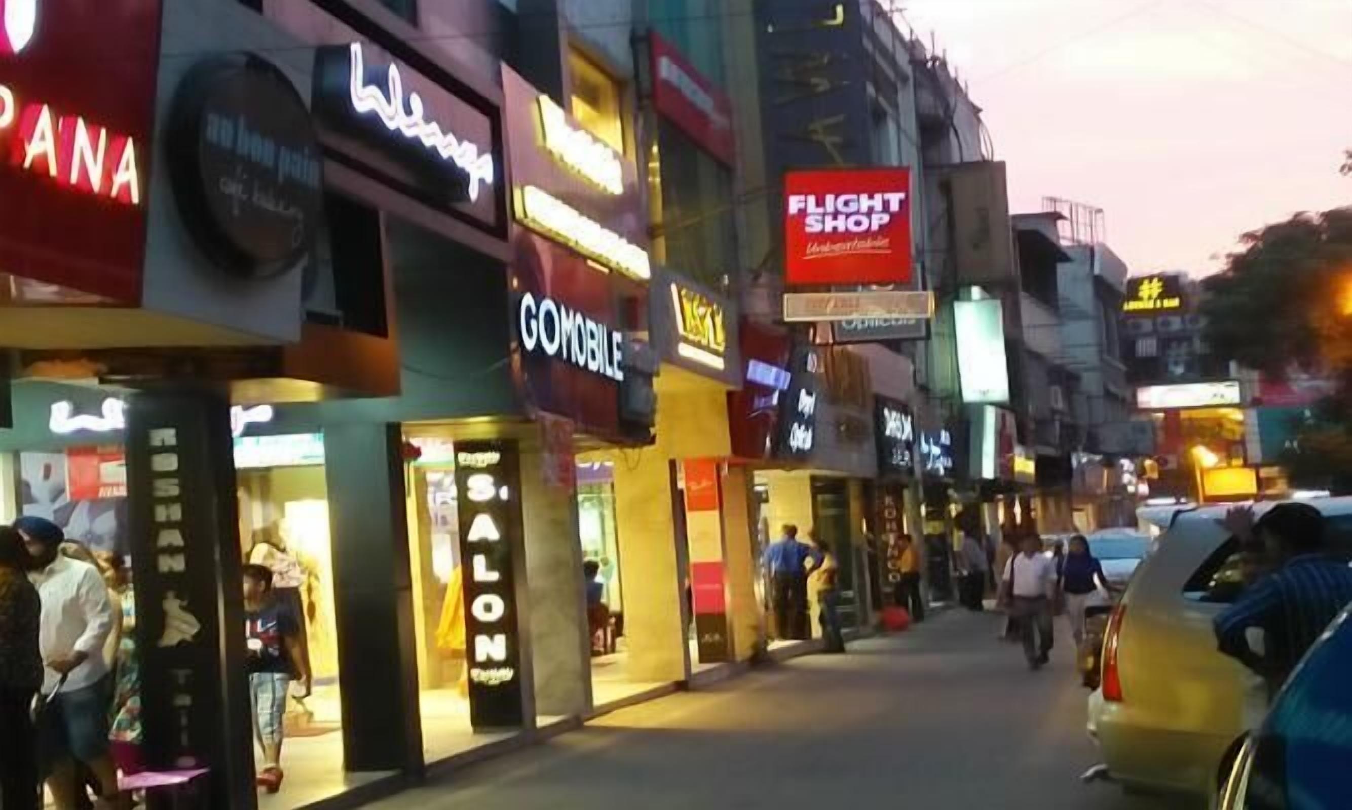 A busy urban street with various shops and a visible 'Flight Shop' sign.