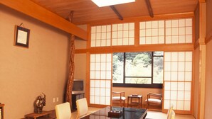 A traditional Japanese room with tatami flooring, a low table with cushions, and sliding shoji doors. - Takaragawa Onsen Osenkaku (Minakami)