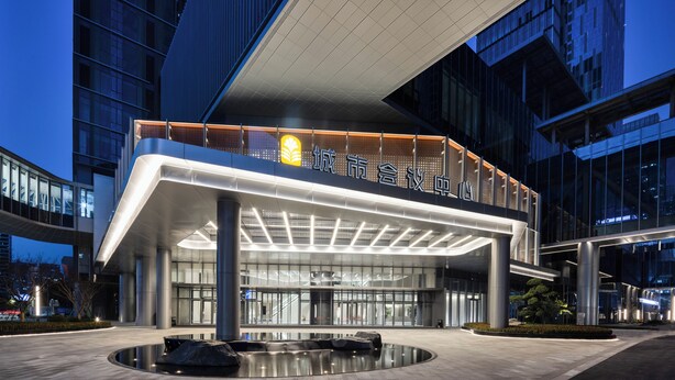 A modern building with a prominent entrance, large glass windows, and a well-lit facade. - Pan Pacific Ningbo (Ningbo)