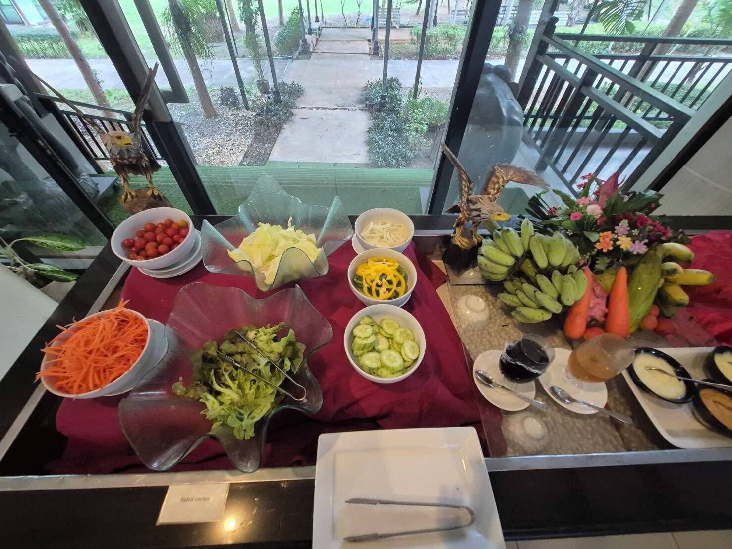 A buffet table with various food items and a salad bar.