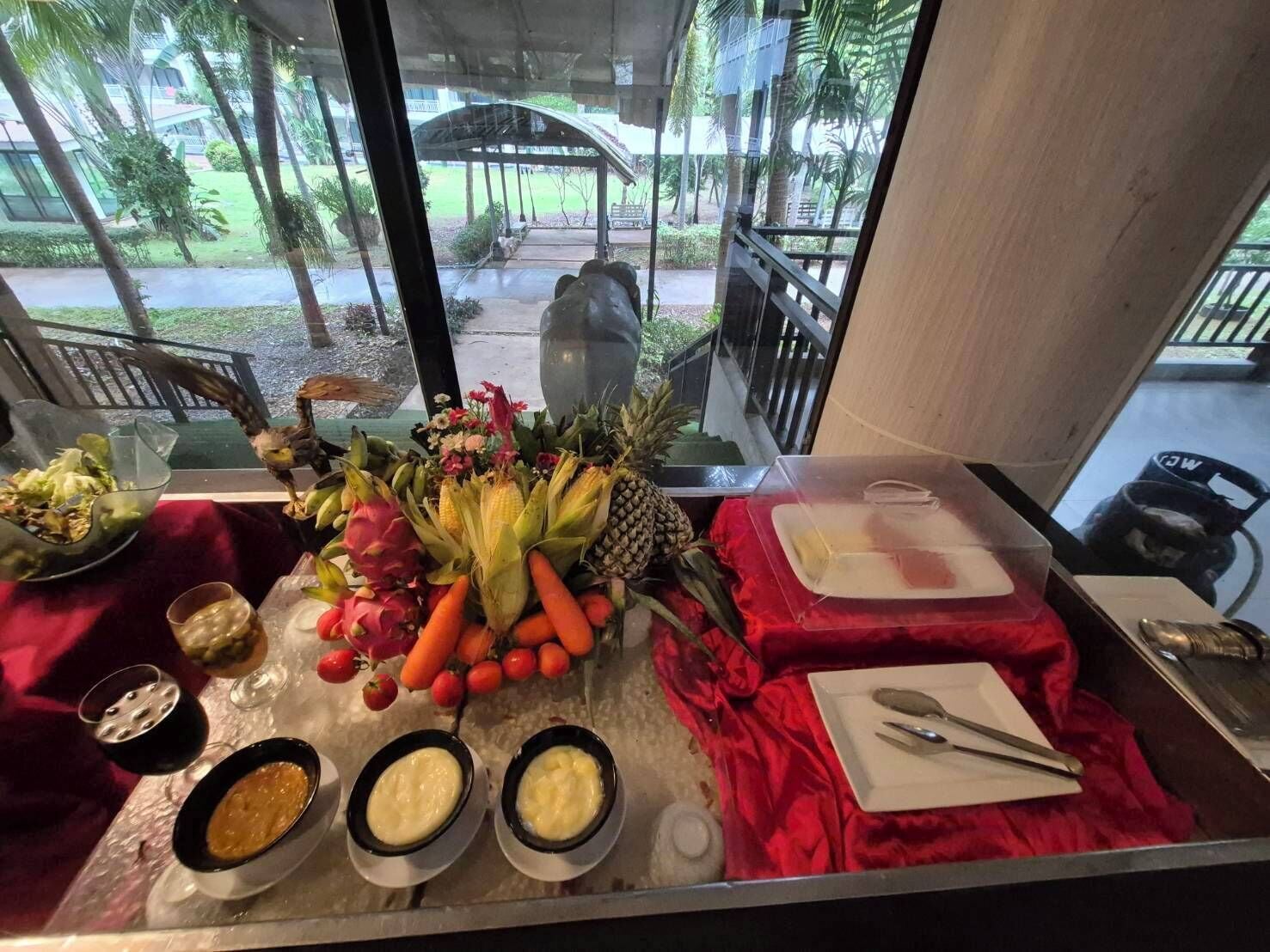 A buffet table with various fruits, vegetables, and condiments.
