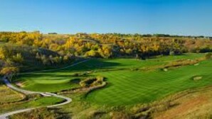 A golf course with a winding path, a well-maintained green, and surrounding trees. - Hampton Inn & Suites Minot Airport (Minot)