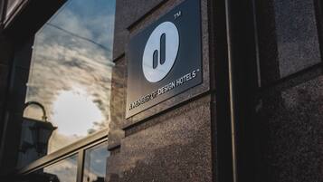 A sign for Design Hotels on a building facade.