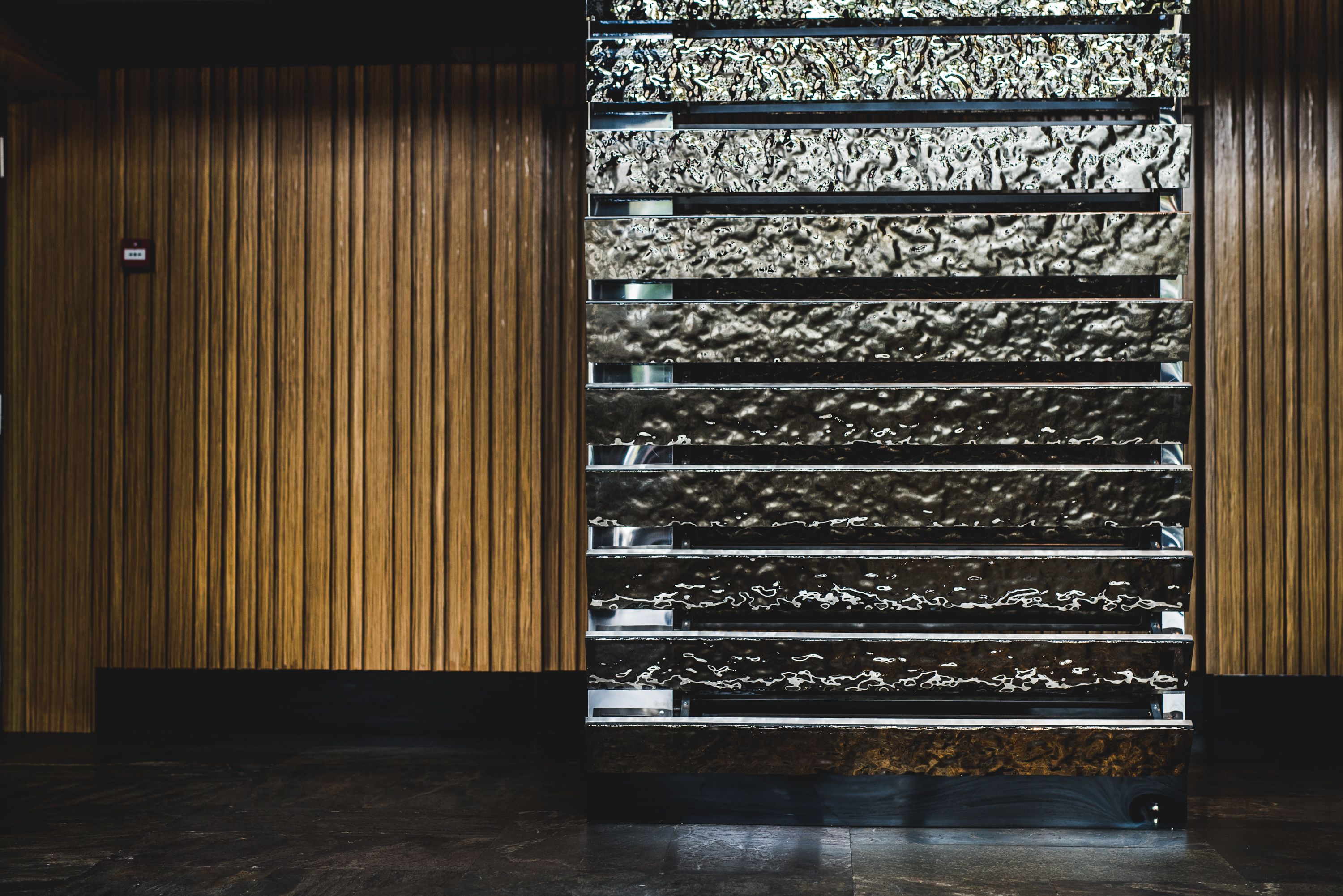 A staircase with a unique, textured wall design.