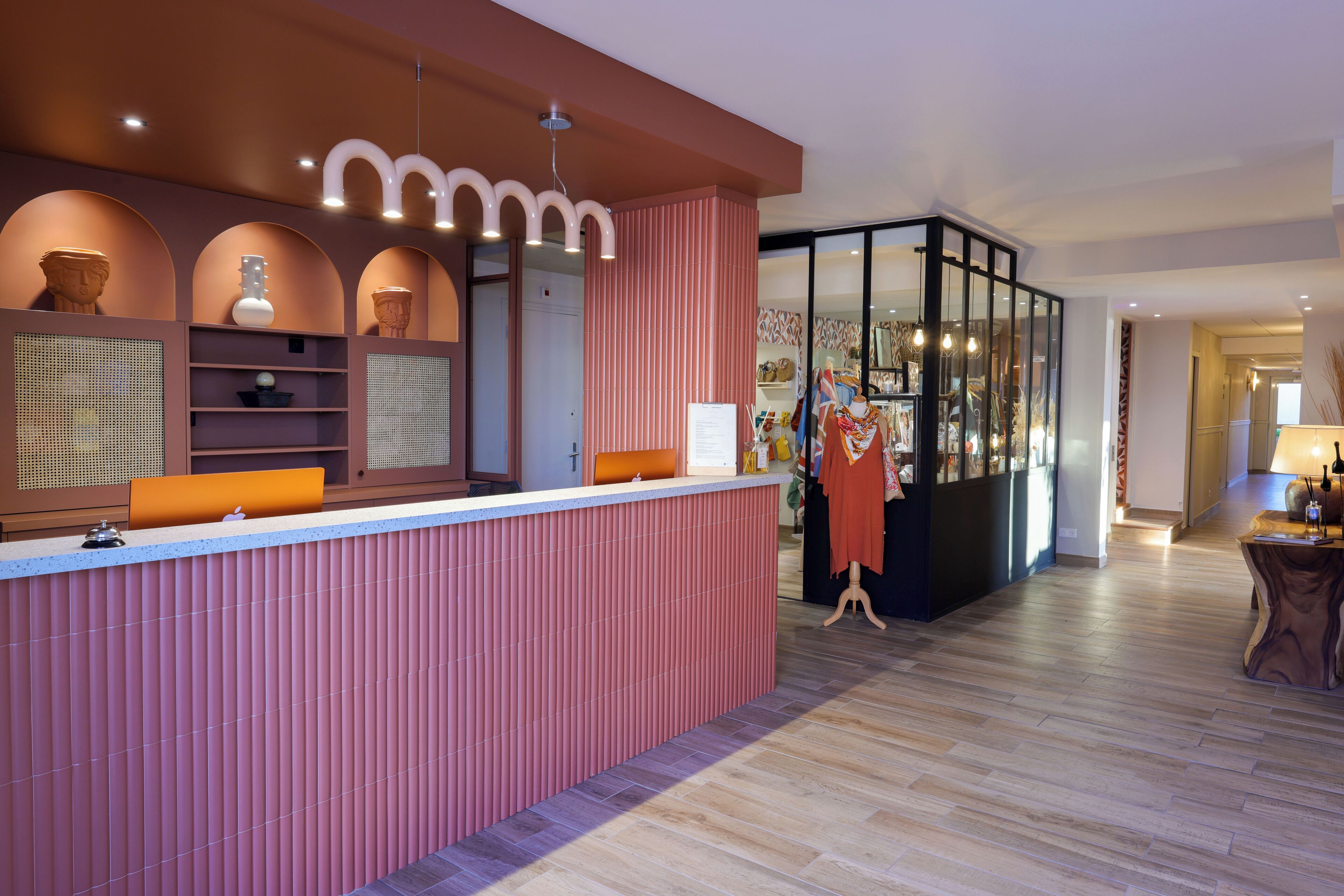 A reception area with a counter, a mannequin, and a display of items.