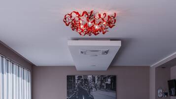 A modern reception area with a reception desk, a large black-and-white photograph on the wall, and a red sofa.