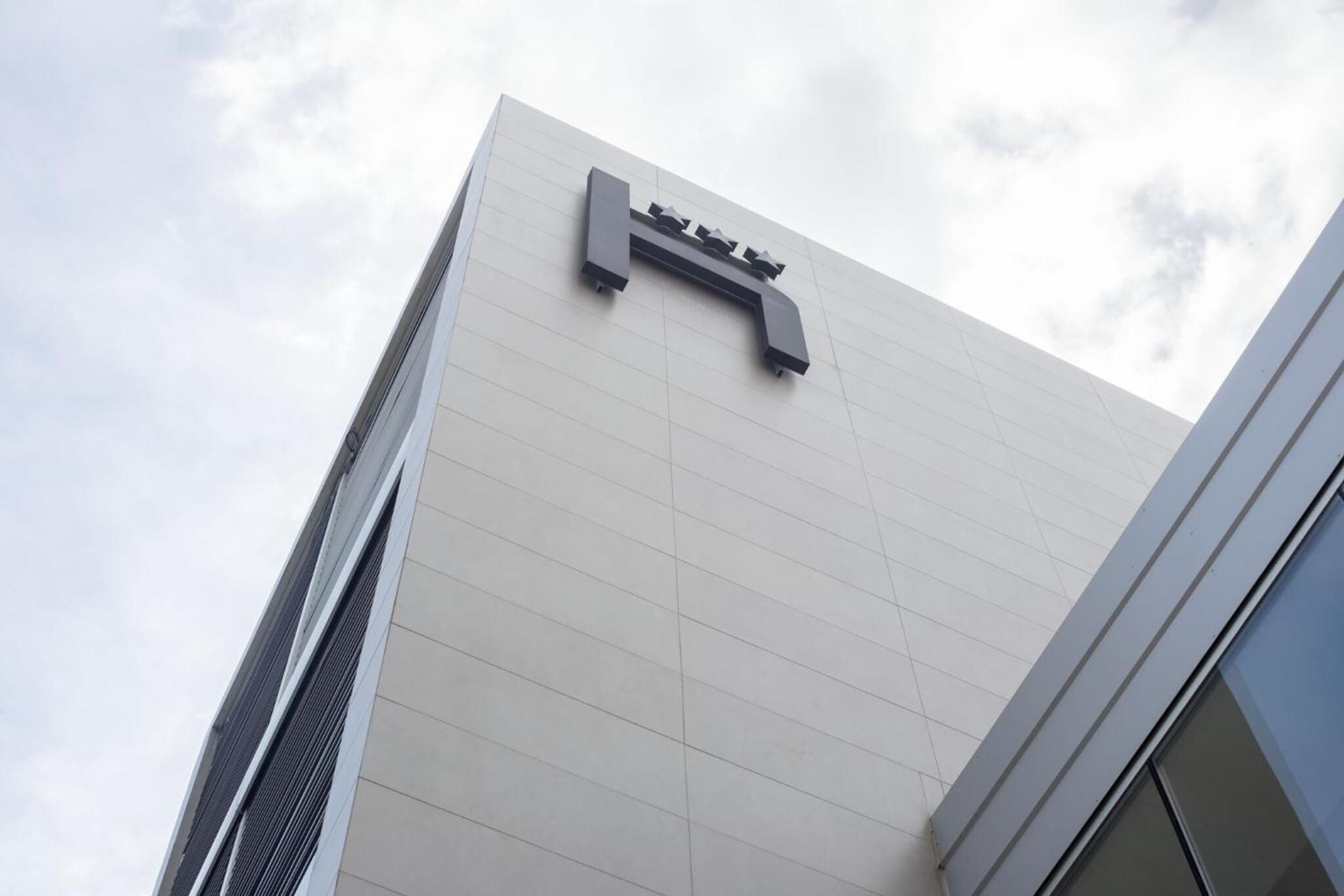 A modern building with a prominent sign.