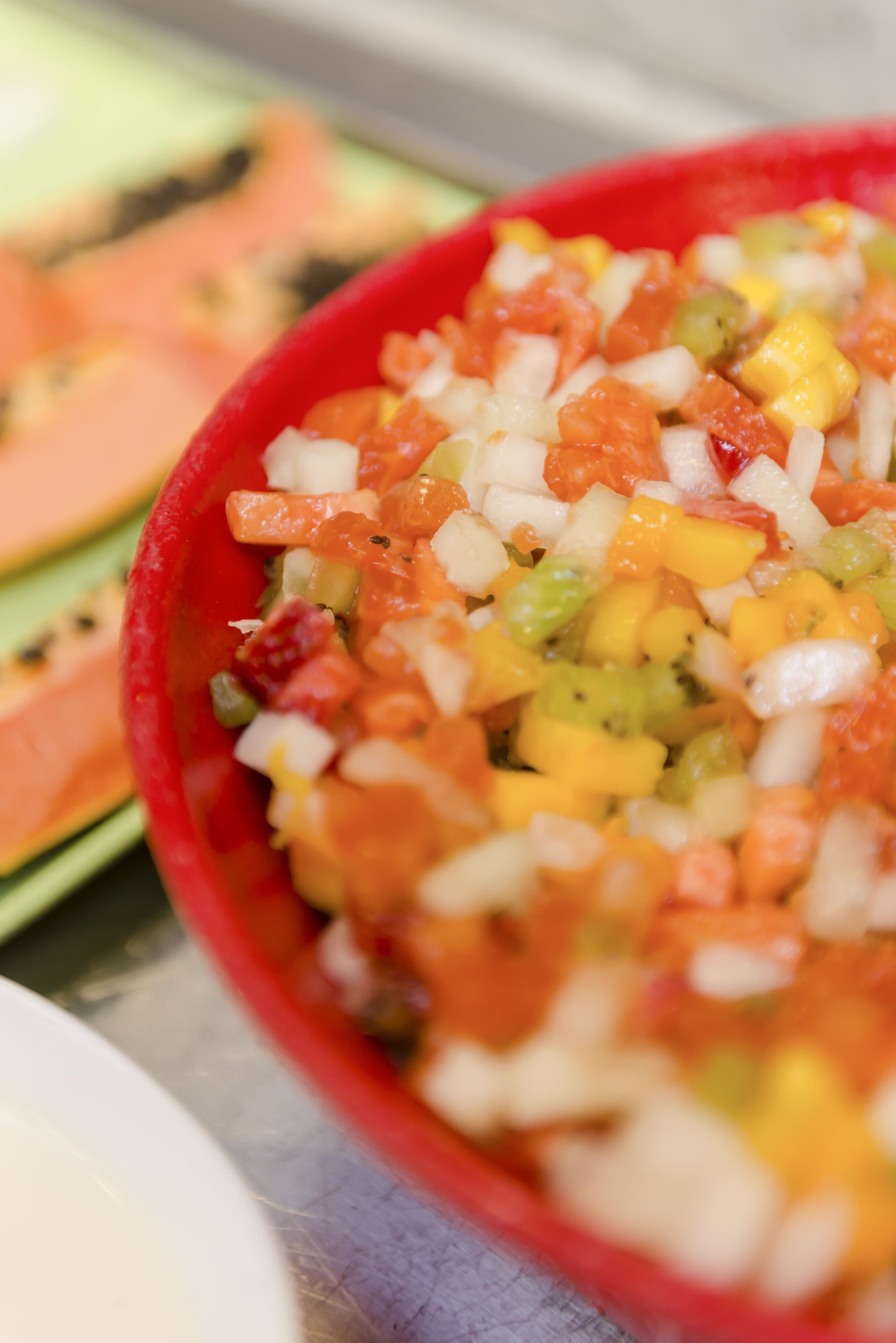 A bowl of fruit salad with various diced fruits.