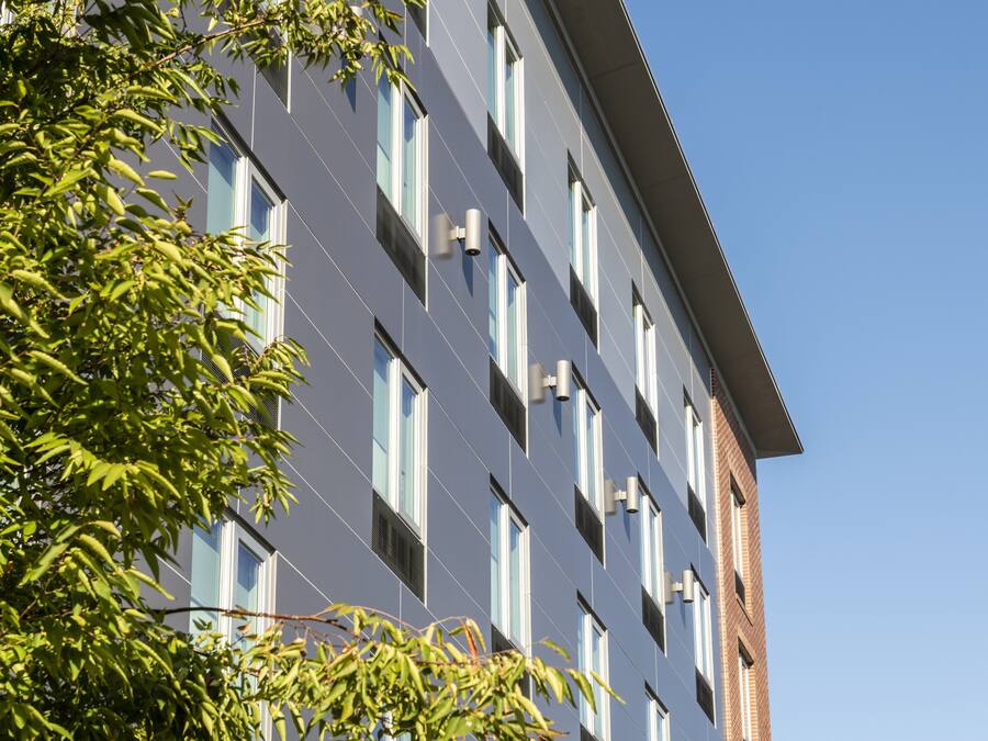 A modern building with multiple windows and a flat roof.
